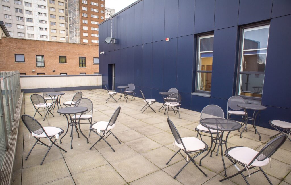 Balcony area with tables and chairs set out