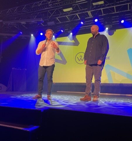 Sam and Rich on stage addressing the audience